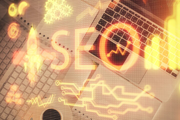 Double exposure of SEO drawing over study table background with computer. Concept of search. Top view.