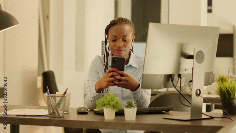 Poster portrait of startup employee using smartphone at office job during sunset, working on business data 