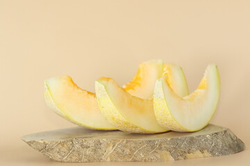 Honey melon slices on wood slice 
