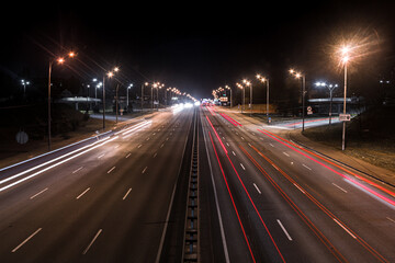 High-speed ring road at night. City at night. Cars on the expressway.
