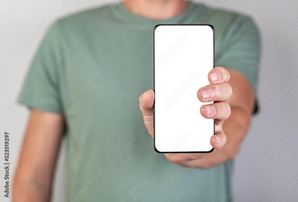 Poster Man holding phone mockup in vertical position. Android with blank display. Person stretching smartphone forward for showing smth. High quality photo