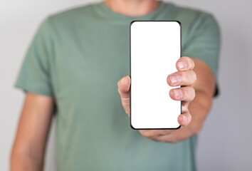 Man holding phone mockup in vertical position. Android with blank display. Person stretching...