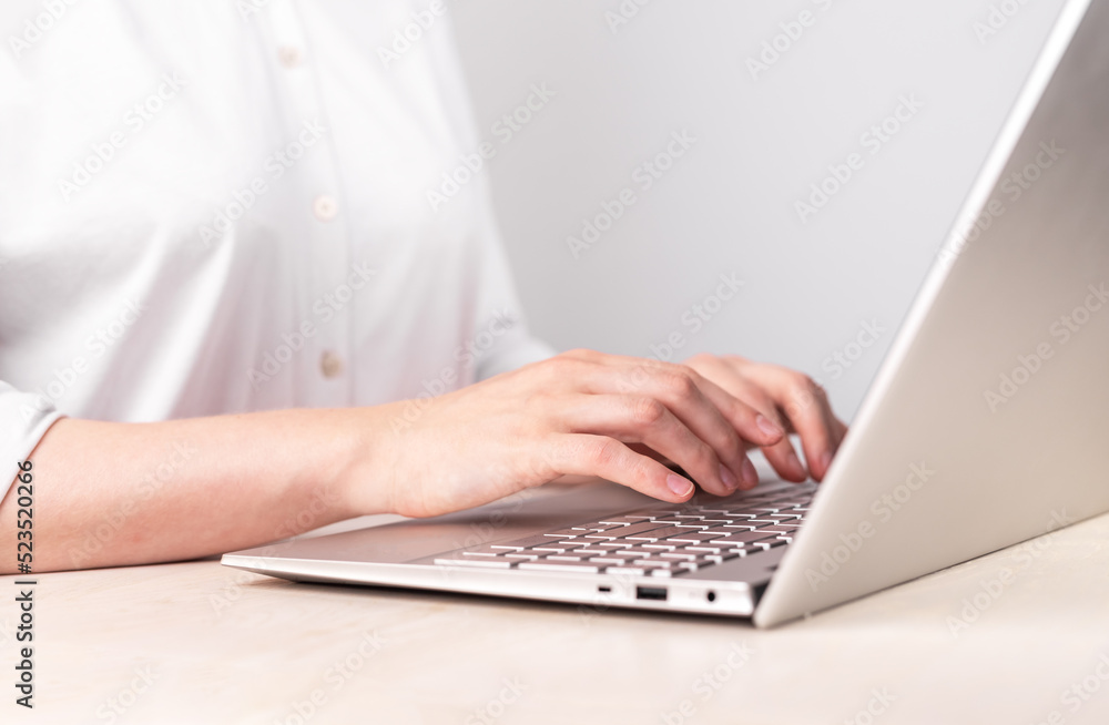Aufkleber Woman hands closeup typing on laptop keyboard. Using computer for work, study. Office manager job. Female sitting at table. High quality photo