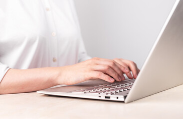 Woman hands closeup typing on laptop keyboard. Using computer for work, study. Office manager job. Female sitting at table. High quality photo