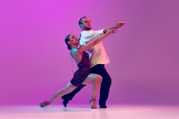 Feelings in dance. Emotional dancers dancing ballroom dance isolated on purple background. Concept...