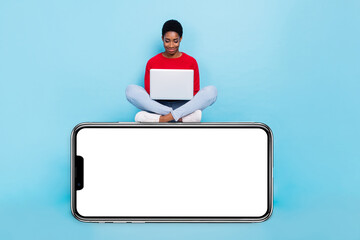 Photo of good mood business person sitting podium working in netbook gadget isolated on blue color background