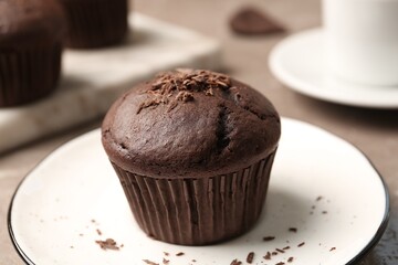 Delicious cupcake with chocolate crumbles on plate, closeup