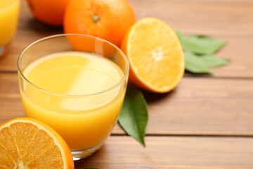 Delicious orange juice and fresh fruit on wooden table, closeup. Space for text