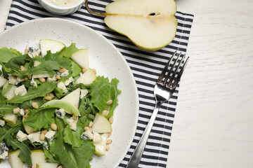 Tasty salad with pear slices served on white wooden table, flat lay