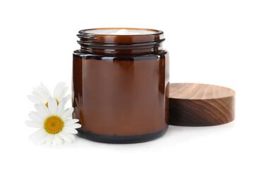 Jar of hand cream and chamomiles on white background