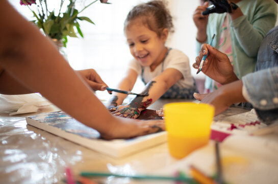 Family Finger Painting At Table