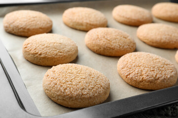 Fototapeta na wymiar Delicious sugar cookies on baking sheet, closeup