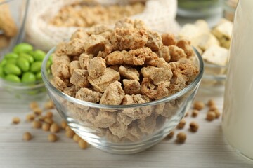 Dehydrated soy meat and other organic products on white wooden table, closeup