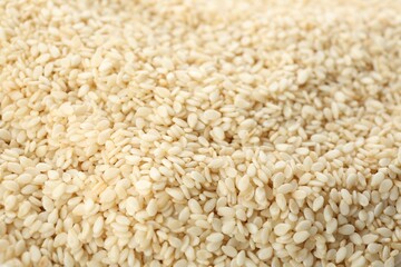 Pile of white sesame seeds as background, closeup
