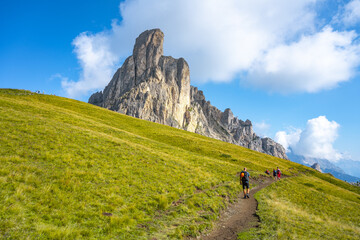 Fototapeta na wymiar Group of hikers walks towards mountains