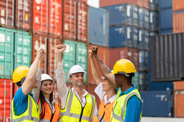 Group of young businessman and woman worker working in container site. Attractive business man and woman laborer standing and stacking hands for motivate and work unity teamwork in cargo freight ship.