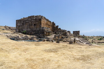 Ruins of the ancient city of Hierapolis, on a sunny day, with blue sky.