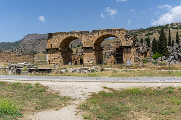 Ruins of the ancient city of Hierapolis, on a sunny day, with blue sky.