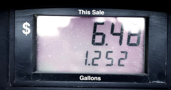 Gas Station Pump Prices High Over 5 Five Dollars Per Gallon 5.15 regular starting at 0 pumping to 69 sped up to be under 60 seconds with dramatic suspenseful camera movements. In Cinema 4K 60fps.