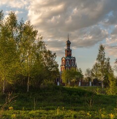 Beautiful summer landscape with a church at sunset