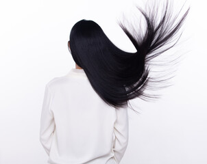 Black Straight Long Black Hair woman throw fly in air with fashion stylish and fun joy. Female turn back wear white shirt express emotion happy by blow wind hair, isolated white background