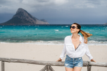 cheerful woman in sunglasses on the island holiday