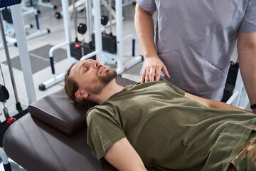 Soldier lies on a massage table in a rehabilitation center