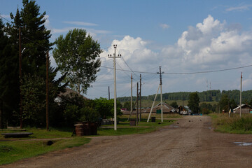 View of the street and power poles on a sunny day