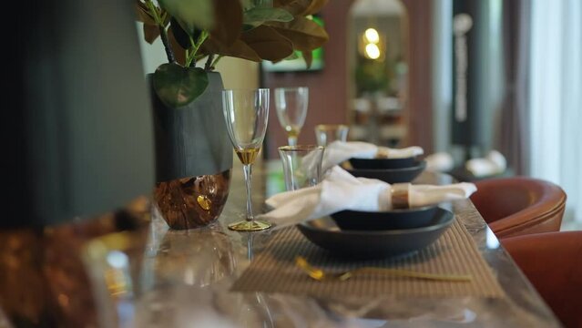 close up of nice beautiful dining chair with wooden table and dish sets interior design vintage color tone with light flare ,beautiful table setting for wedding or other celebration home design