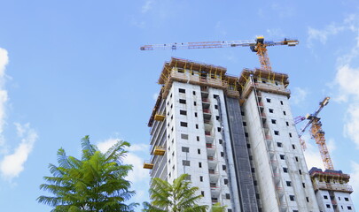 Naklejka premium Construction work site. Building yard of Housing construction of houses in a new area of the city. The site with cranes Construction business, real estate investment
