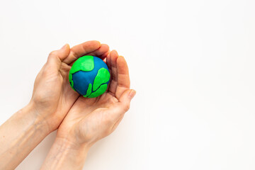 Modeling clay world in hands. Earth Day concept