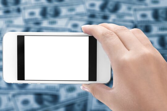 Hand hold phone and money on the background. is the central banking system of the United States of America.