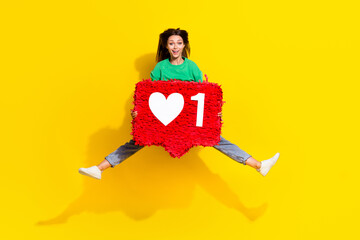 Full size portrait of excited pretty girl jump arms hold big like collage isolated on yellow color background