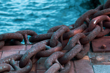 ship mooring chain. Rusty big chains by the sea. Iron ship mooring rope.