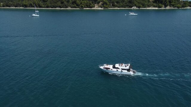 speedboat leaves a white trail on the calm surface of the Adriatic Sea, Croatia, Rab island archipelago, summer
