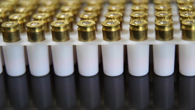 Rows of 9MM gun ammunition bullets - macro turning