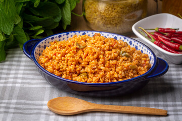 Traditional turkish bulgur pilaf with tomato sause in plate (Turkish name; meyhane pilavi)