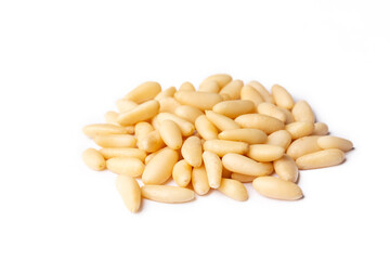 Pine nuts in the spoon and pine nut cone on the wooden table. Organic food.