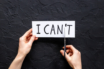 Hands changing words I cannot to I can with scissors. Selfmade concept