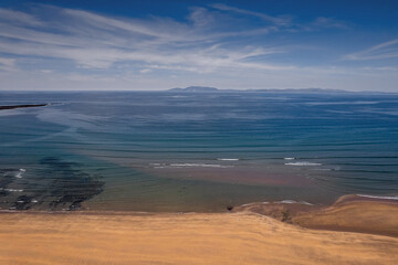 Aerial view on Streedagh beach in county Sligo, Ireland. Beautiful nature scene with warm yellow sand and blue ocean and clear blue sky. Popular tourist area. Warm sunny day.
