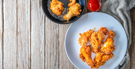 Fried chicken food and french fries on a wooden table
