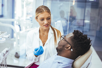 Obraz premium A perfect result of a dentist’s work which is seen in the beautiful and white smile on a patient who is absolutely satisfied with a result of a treatment given in a clinic. 