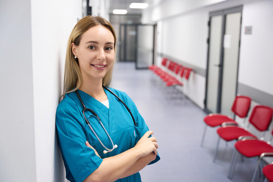 Woman doctor standing against the wall in the hospital