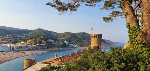 Tossa de Mar Spain July 2022 beautiful golden hour view over Tossa town from castle over bay with boats