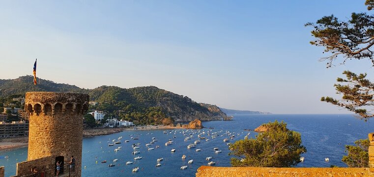 Tossa de Mar Spain July 2022 beautiful golden hour view over Tossa town from castle over bay with boats