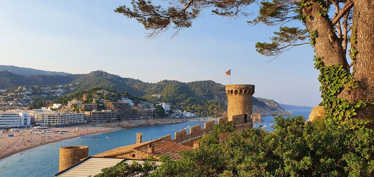 Tossa de Mar Spain July 2022 beautiful golden hour view over Tossa town from castle over bay with boats