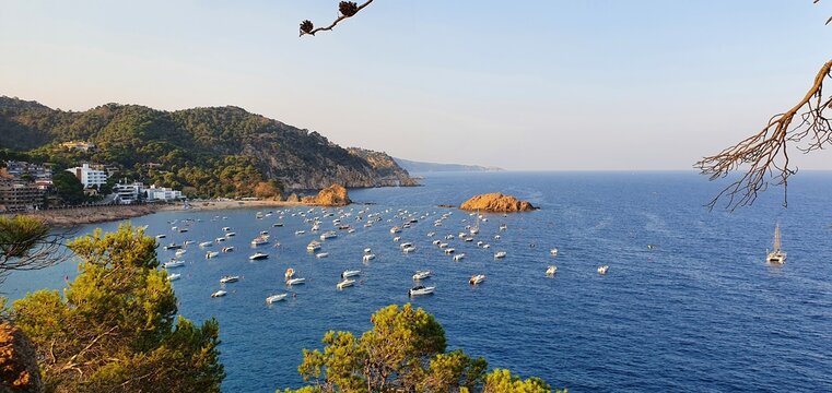 Tossa de Mar Spain July 2022 beautiful golden hour view over Tossa town from castle over bay with boats