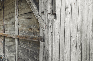 Side view of a wooden wall in a weathered wooden style. Old wooden barn wall. Wooden nails.
