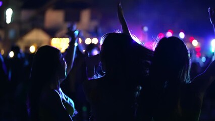 4K Group of Asian woman celebrating and dancing together at tropical island beach full moon party at night. Happy girl friends enjoy outdoor lifestyle beach holiday summer travel vacation in Thailand