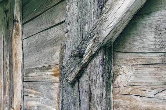 Old wooden barn wall. Side view of a wooden wall in a weathered wooden style. Wooden nails.